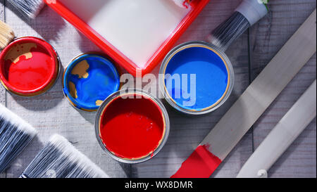 Paint can and paintbrushes of different size  for home decorating purposes. Stock Photo