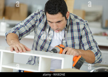 drilling the holes in furniture Stock Photo