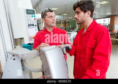 industrial workers having a conversation Stock Photo