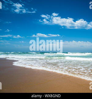 Yellow sand beach, sea and deep blue sky. Stock Photo