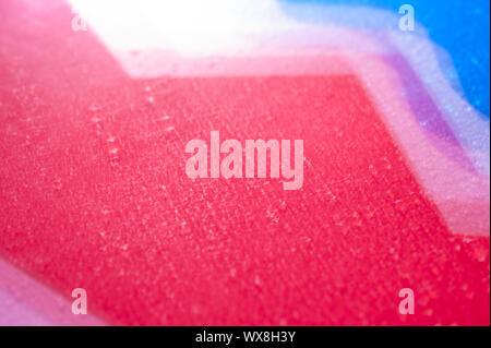 Drops on a shiny surface with a motion blur effect. Violet tonality in the style of the 80-90s. Stock Photo