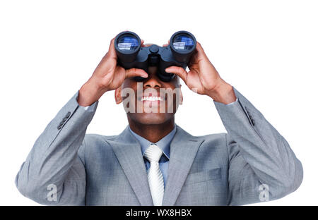Smiling businessman looking through binoculars against a white background Stock Photo