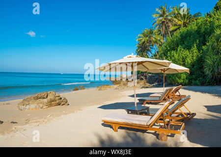 Pair of deck chairs at tropical beach Stock Photo