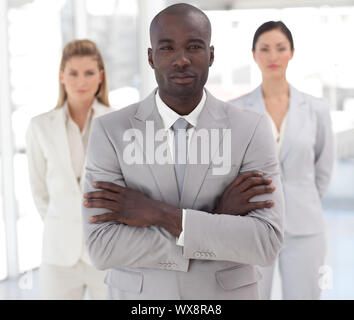 Self-assured afro-american manager with his team in a office Stock Photo