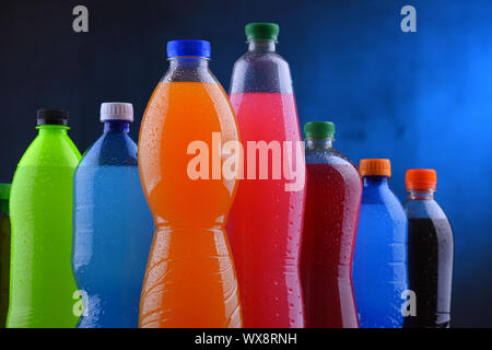 Plastic bottles of assorted carbonated soft drinks in variety of colors Stock Photo