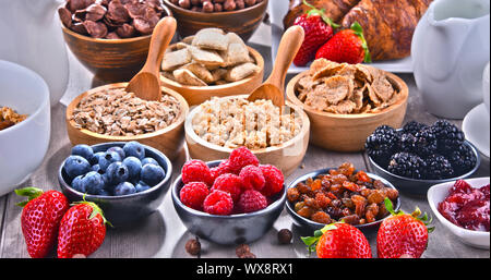 Composition with different sorts of breakfast cereal products and fresh fruits. Stock Photo