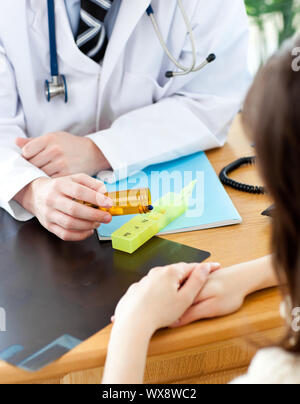 Portrait a confident male doctor giving note to a patienr Stock Photo