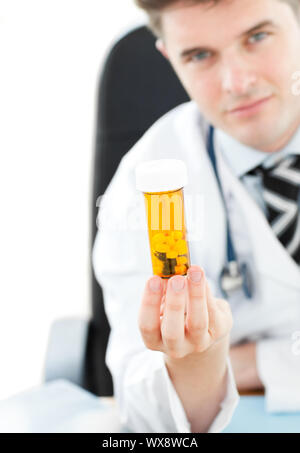 Doctor holding pills in his office Stock Photo