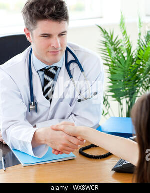 Confident doctor with his upset patient Stock Photo
