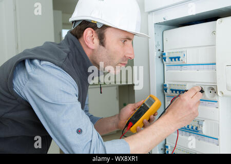 man working using multimeter electrician concept Stock Photo