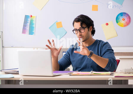 Young handsome designer working at the project Stock Photo