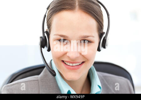 Portrait of a friendly operator with earpiece in the office Stock Photo