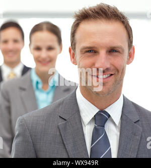 Businessmen and businesswman posing together in a row in the office Stock Photo