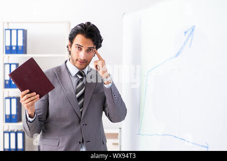 Young handsome businessman in front of whiteboard Stock Photo