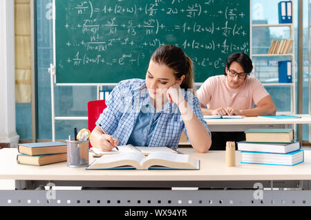 Young students taking the math exam in classroom Stock Photo