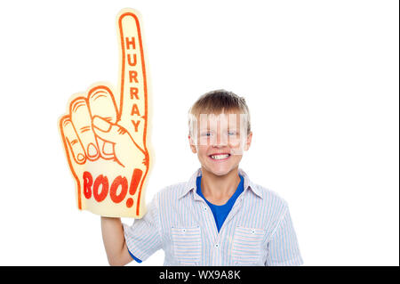 Handsome boy with a hurray boo foam hand pointing skywards on isolated white background Stock Photo