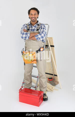 Carpenter with a toolbox and stepladder Stock Photo