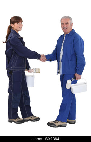 Two painter shaking hands. Stock Photo