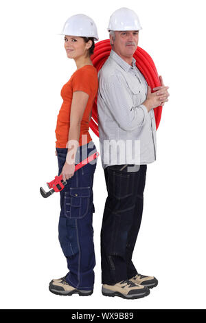 Young and old plumbers Stock Photo