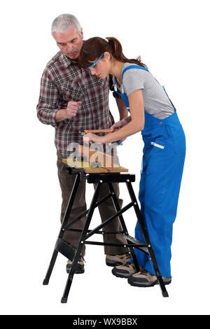 Man and woman doing carpentry work Stock Photo