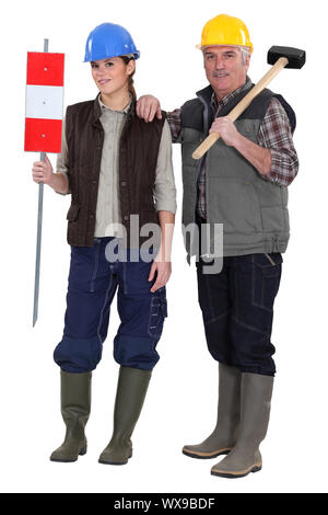 craftsman and young apprentice posing together Stock Photo