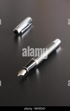 pen showing communication contact us or mail concept on black background Stock Photo
