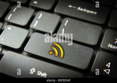 Golden technology RSS icon key on laptop keyboard. Included clipping path, so you can easily edit it. Stock Photo