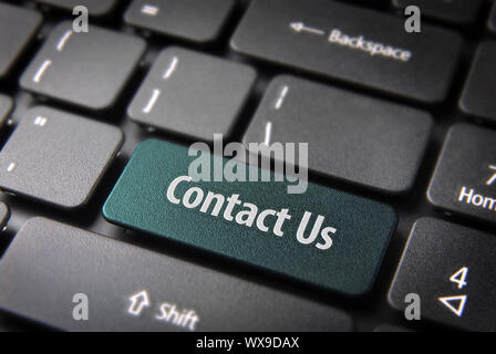 Website template section key with Contact us text on laptop keyboard. Included clipping path, so you can easily edit it. Stock Photo