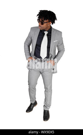 A black young man standing in a gray suit and sunglasses Stock Photo