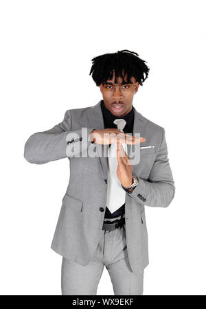 Young black man standing in a suit giving sign to talk Stock Photo