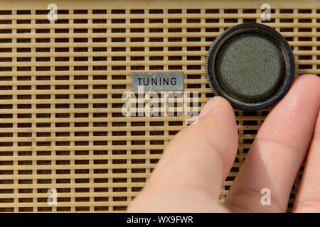 hand with tuner radio knob Stock Photo