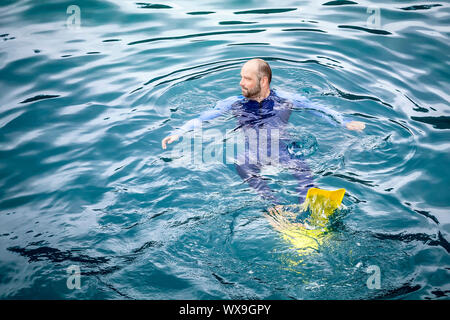 An image of a man swimming in his safetysuit Stock Photo