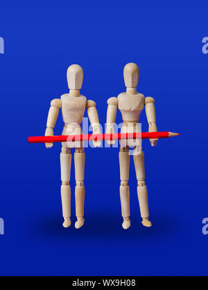 Wooden toy figures with pencil on blue Stock Photo