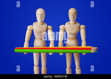 Wooden toy figures with pencils on blue Stock Photo