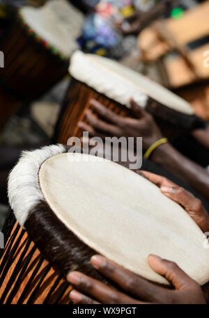 African drummers drumming playing on djembe drum on westafrica music rhythm culture festival afro beat Stock Photo