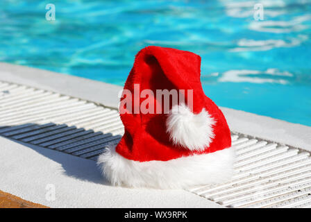 Santa hat near the swimming pool Stock Photo