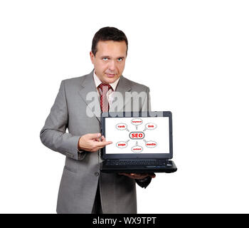 man with a laptop in hand points to seo Stock Photo