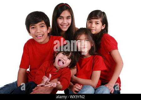 Five siblings with red shirts isolated on white Stock Photo