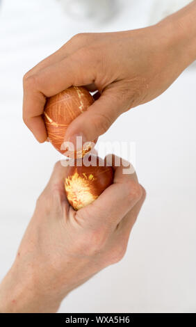 man and woman egg tapping at Easter with naturally colored eggs Stock Photo