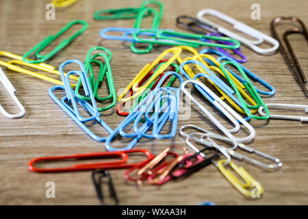 Bunch of color paperclips on a a table Stock Photo