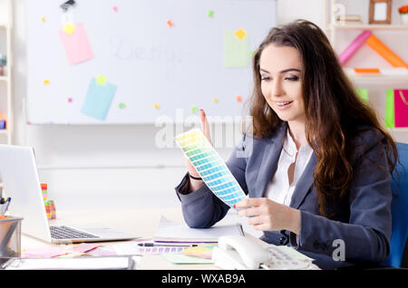 Young female designer working in the office Stock Photo