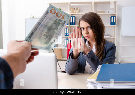 Beautiful female employee unhappy with excessive work Stock Photo