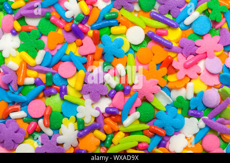 Mixed Candy Cookie and Cupcake Sprinkles Background. Stock Photo