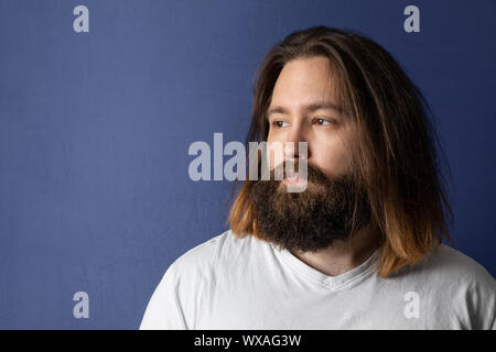 bearded young man with long hair Stock Photo