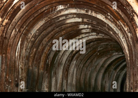 An old tunnel with an arched metal beams Stock Photo