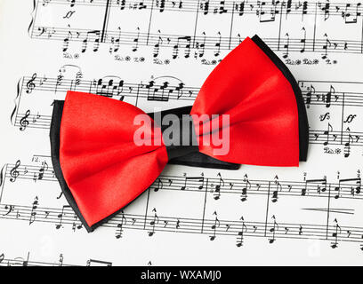 Red bow tie on music sheet Stock Photo