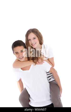Happy teenage girl getting a piggyback from her brother or boyfriend as they enjoy a fun moment of closeness and affection isolated on white Stock Photo