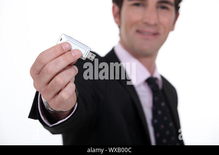 businessman holding a flash drive Stock Photo
