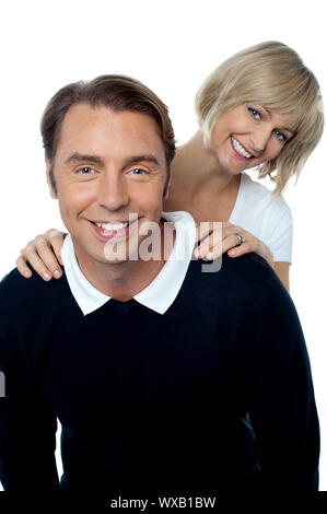 Love couple posing casually in front of camera. All against white background. Stock Photo