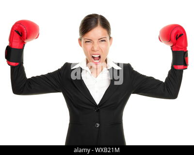 Boxing gloves business woman angry - business concept showing aggressive female businessperson flexing muscles wearing boxing gloves isolated on white Stock Photo